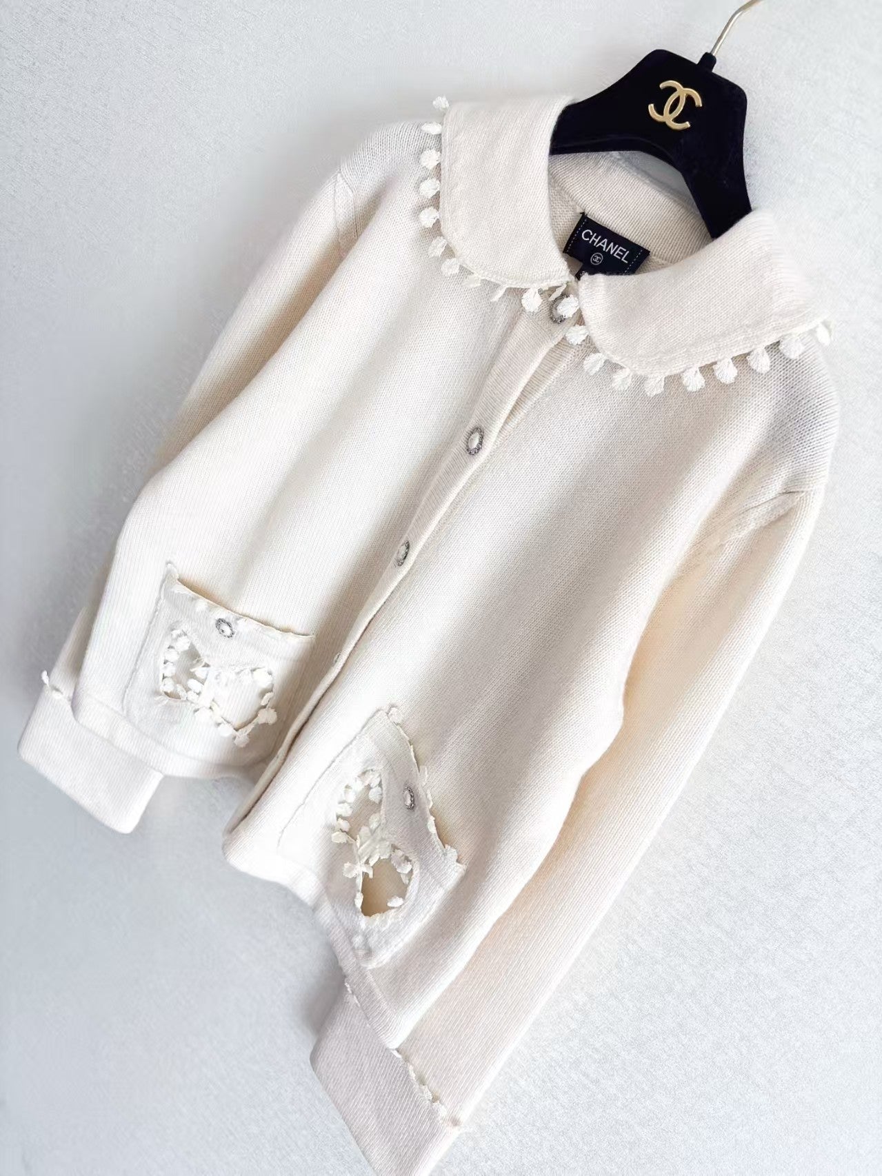 New openwork pocket Peter Pan collar cardigan