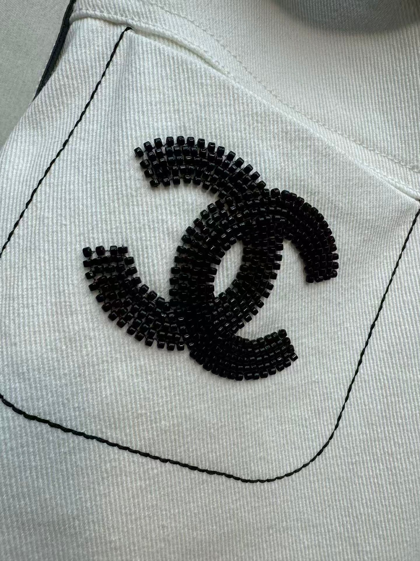 New double-C white denim jeans