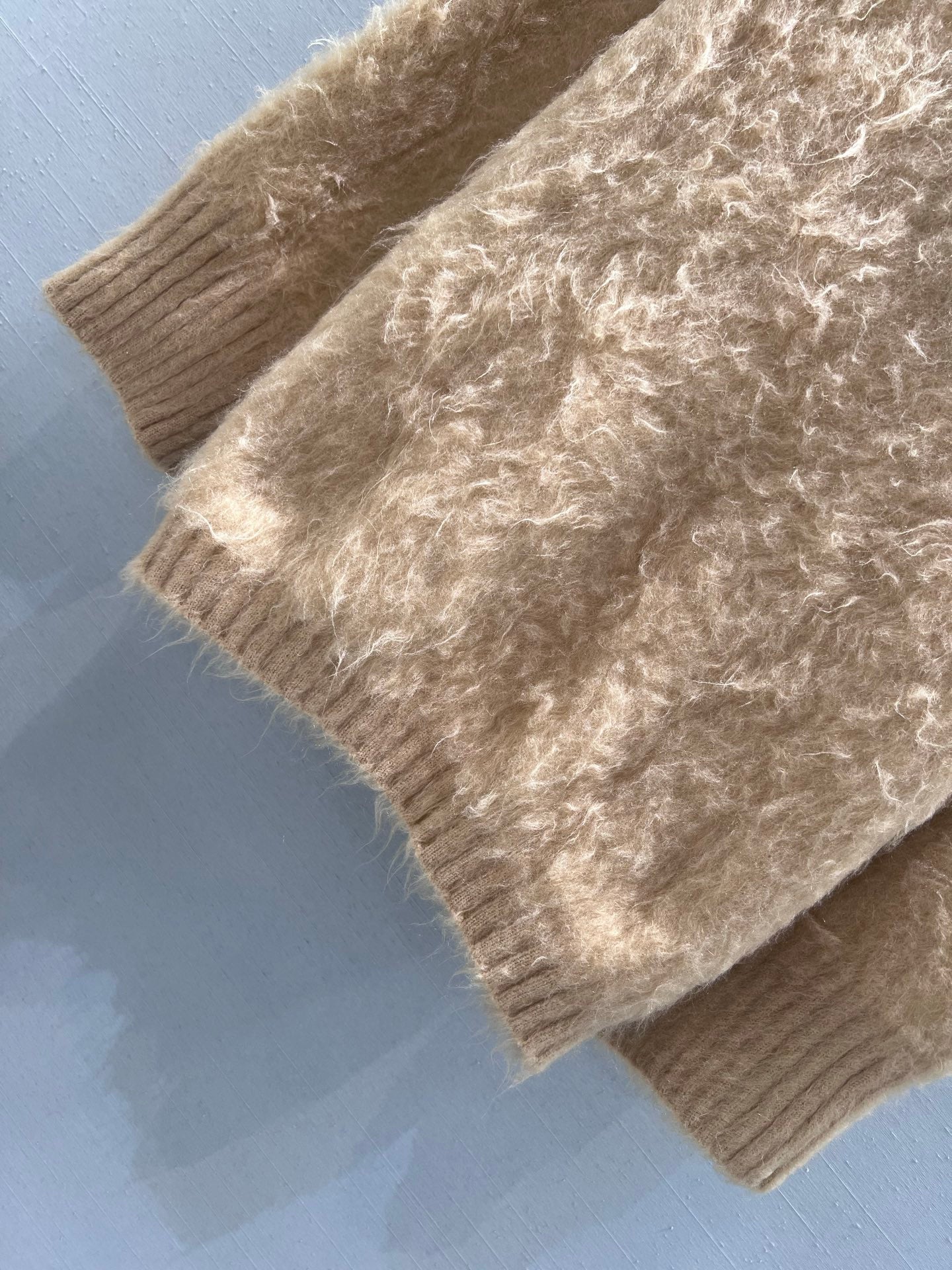 New camel-colored knitted sweater
