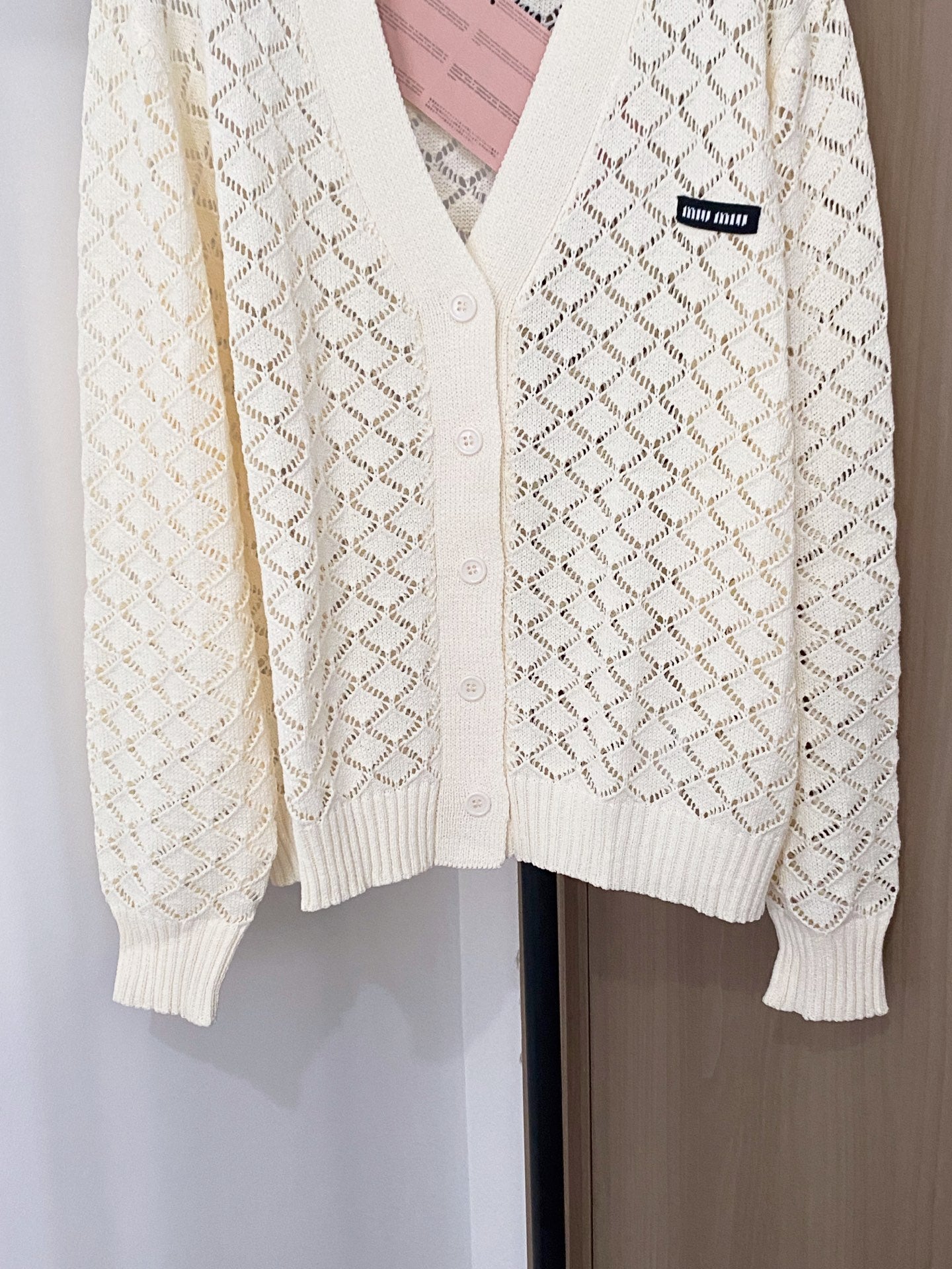 Cardigan embellished with logo details.