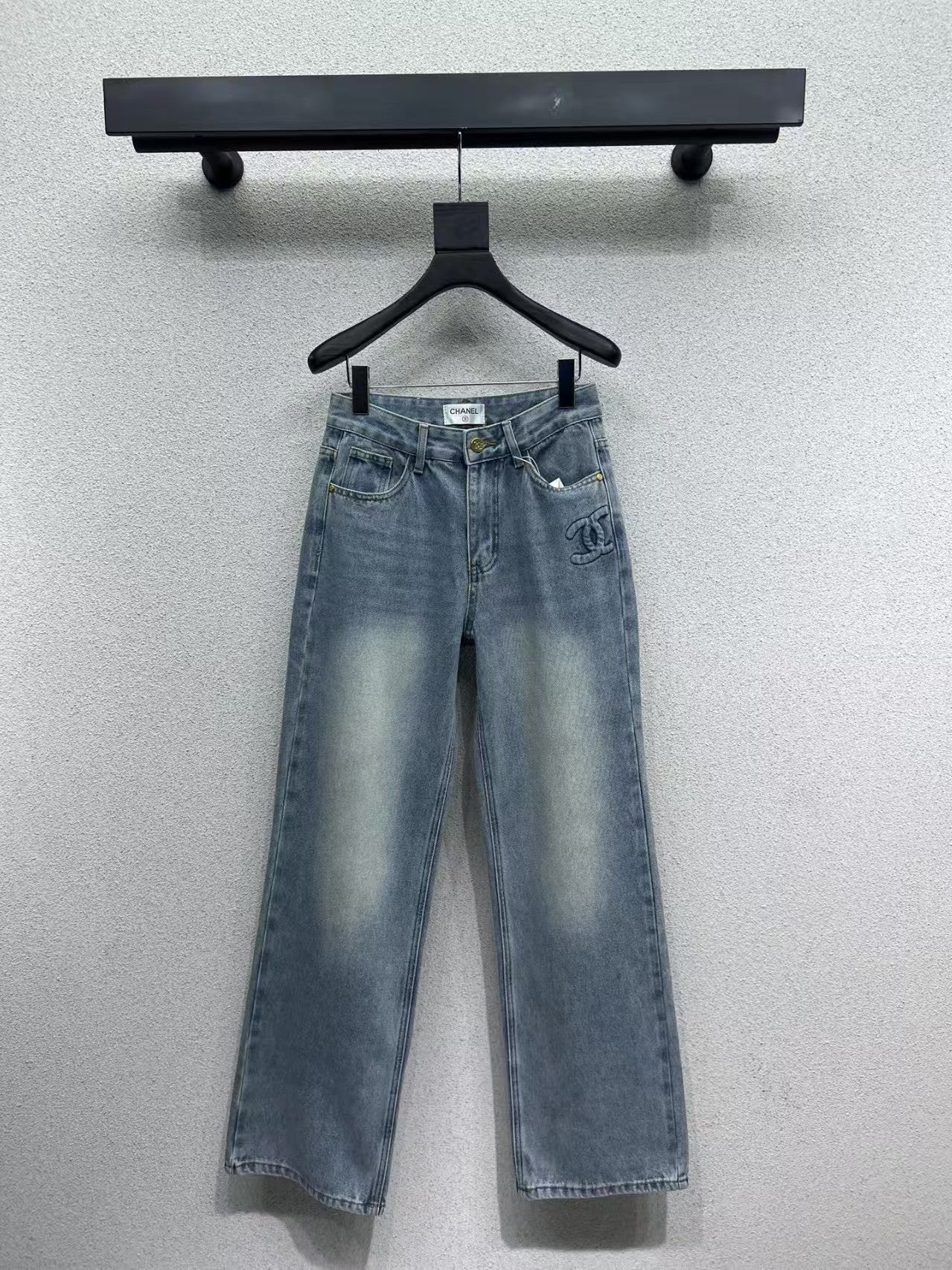 Denim trousers with embossed logo on pocket