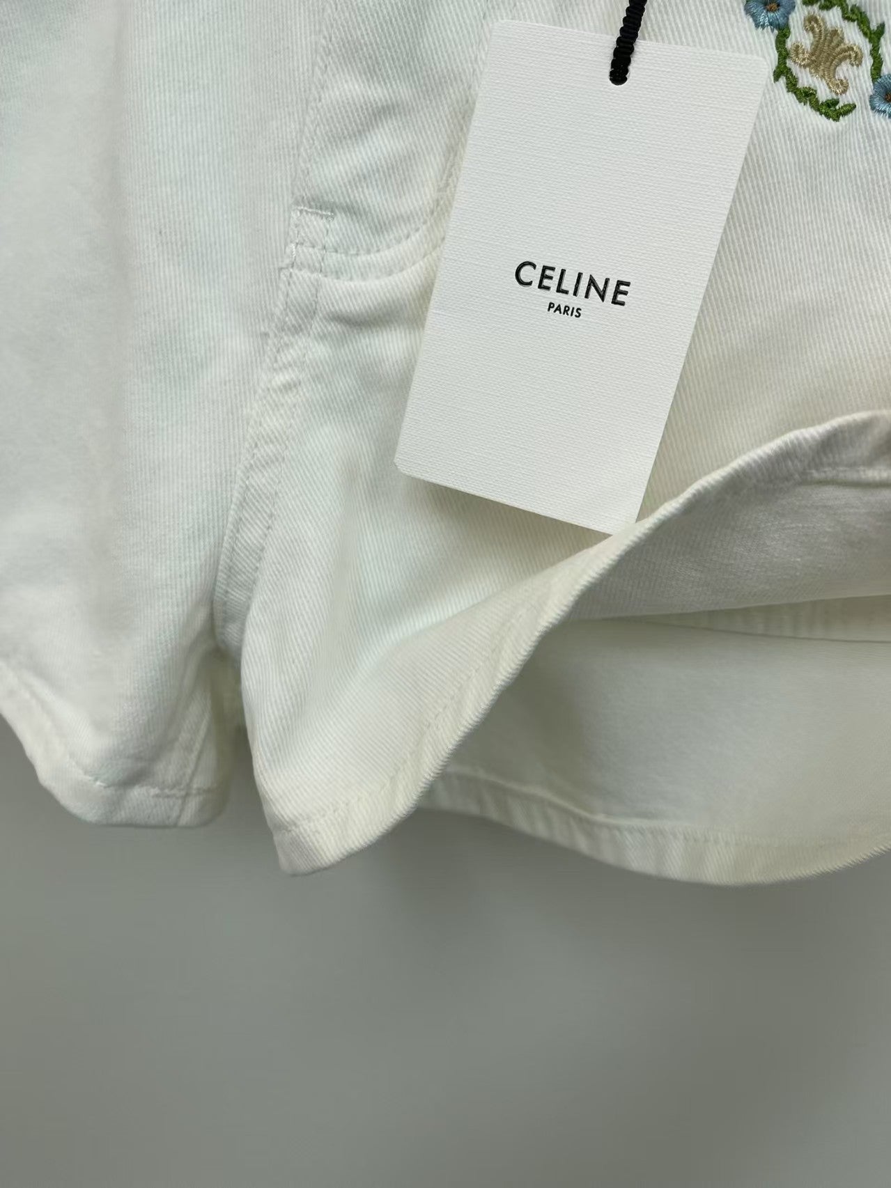 White denim shorts with embroidered letters