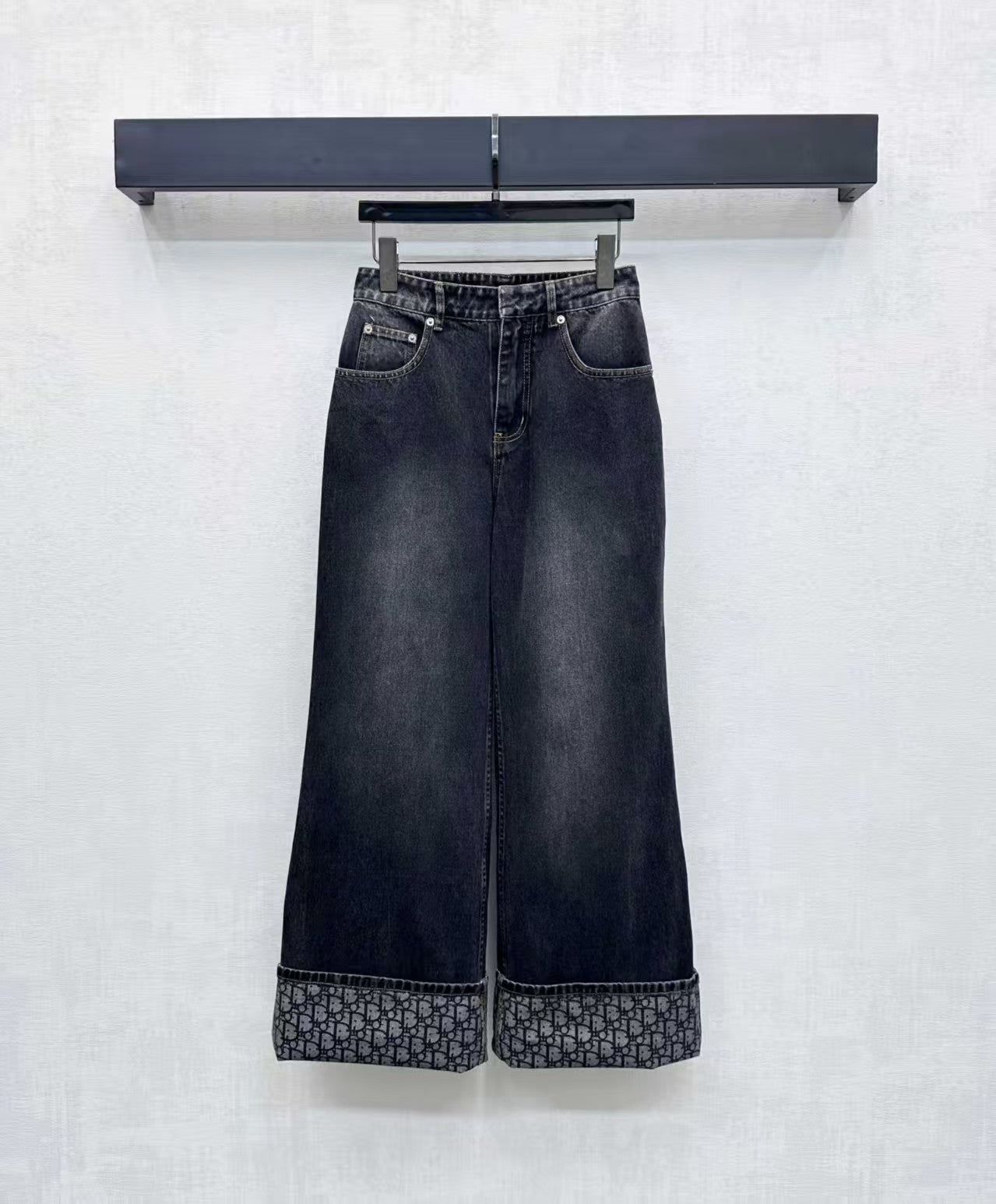 High-waisted bleached denim trousers