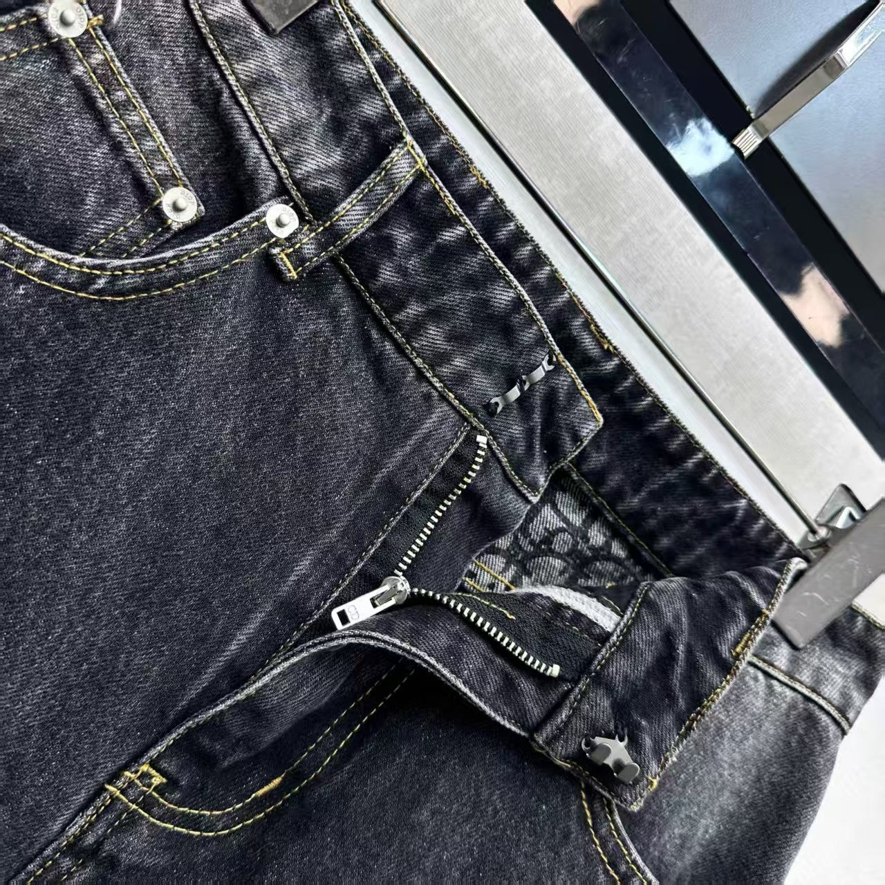 High-waisted bleached denim trousers