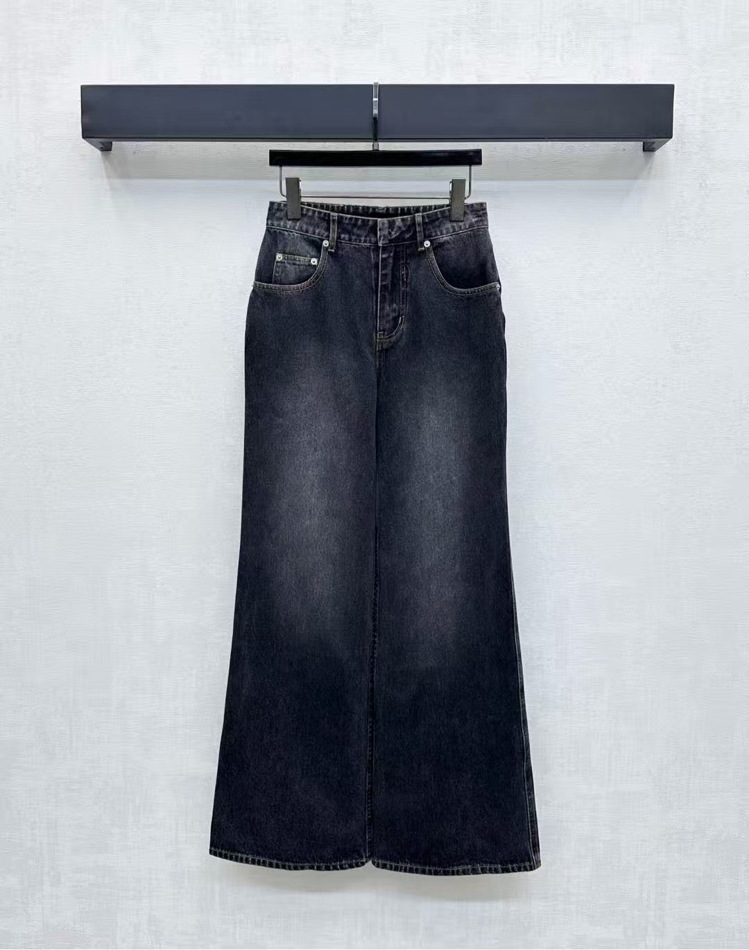 High-waisted bleached denim trousers