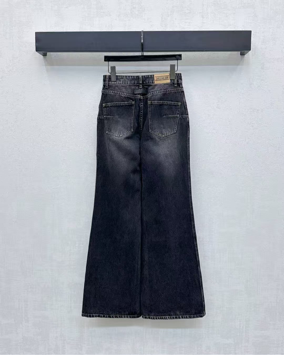 High-waisted bleached denim trousers