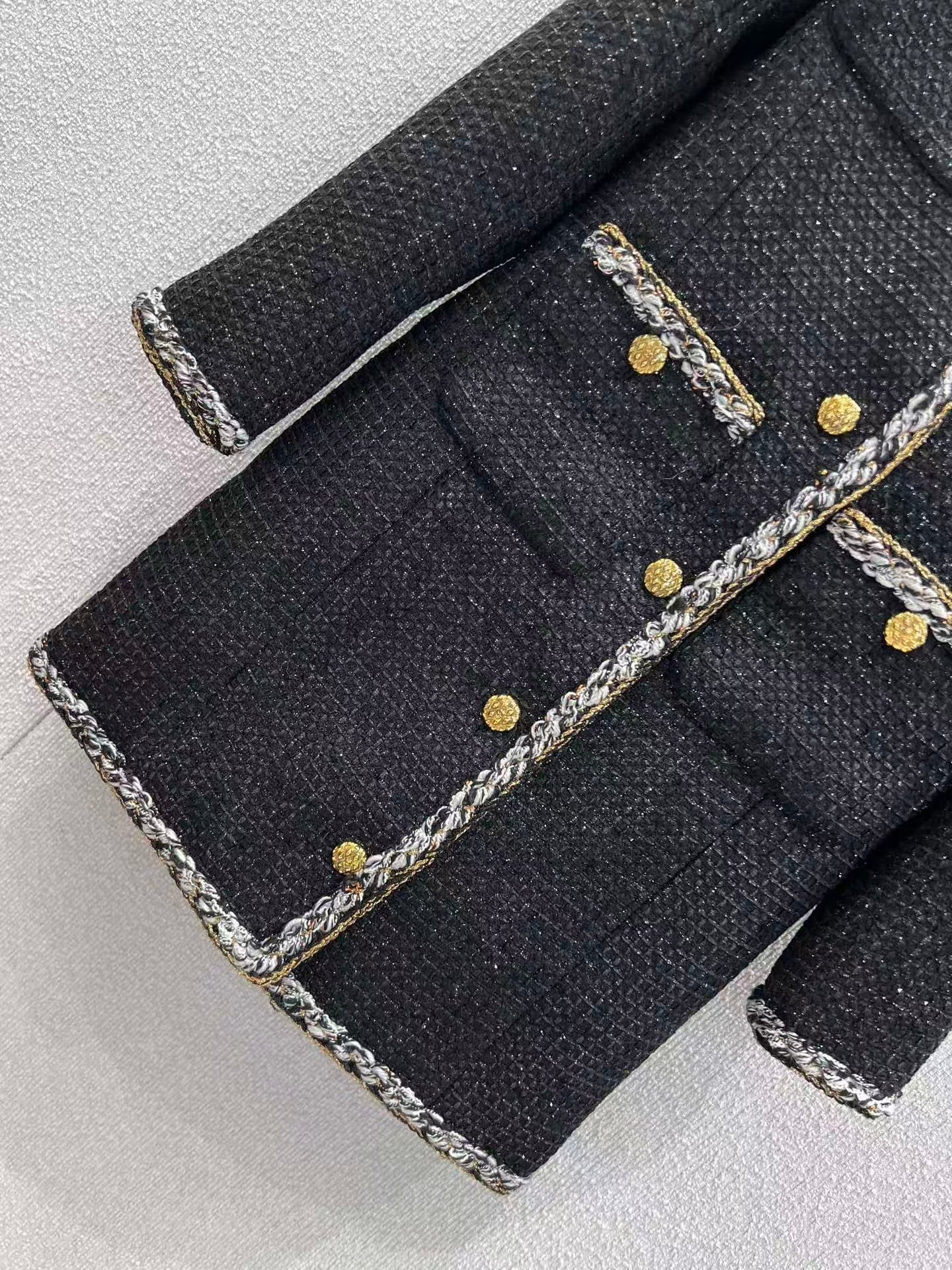 Black and gold four-pocket tweed coat