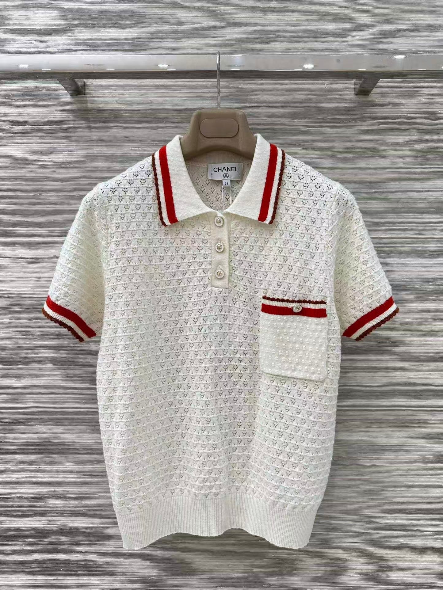 Retro-style polo shirt with cut-out details.