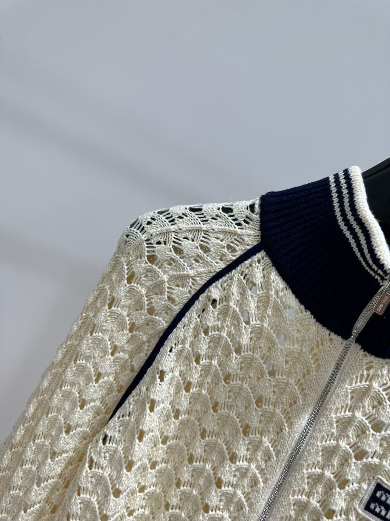 26SS Beige Badge Stand Collar Hollow-Out Cardigan