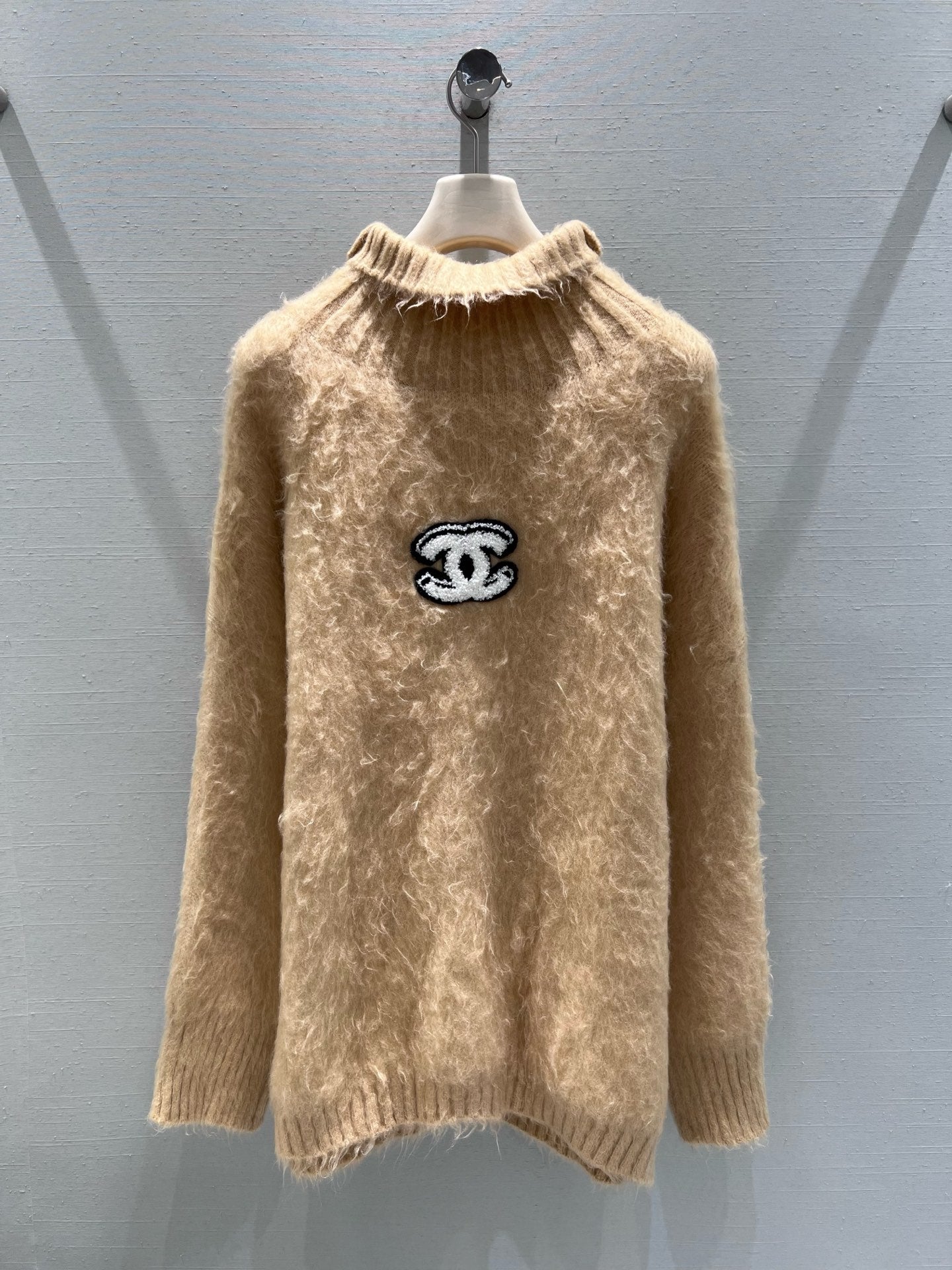New camel-colored knitted sweater