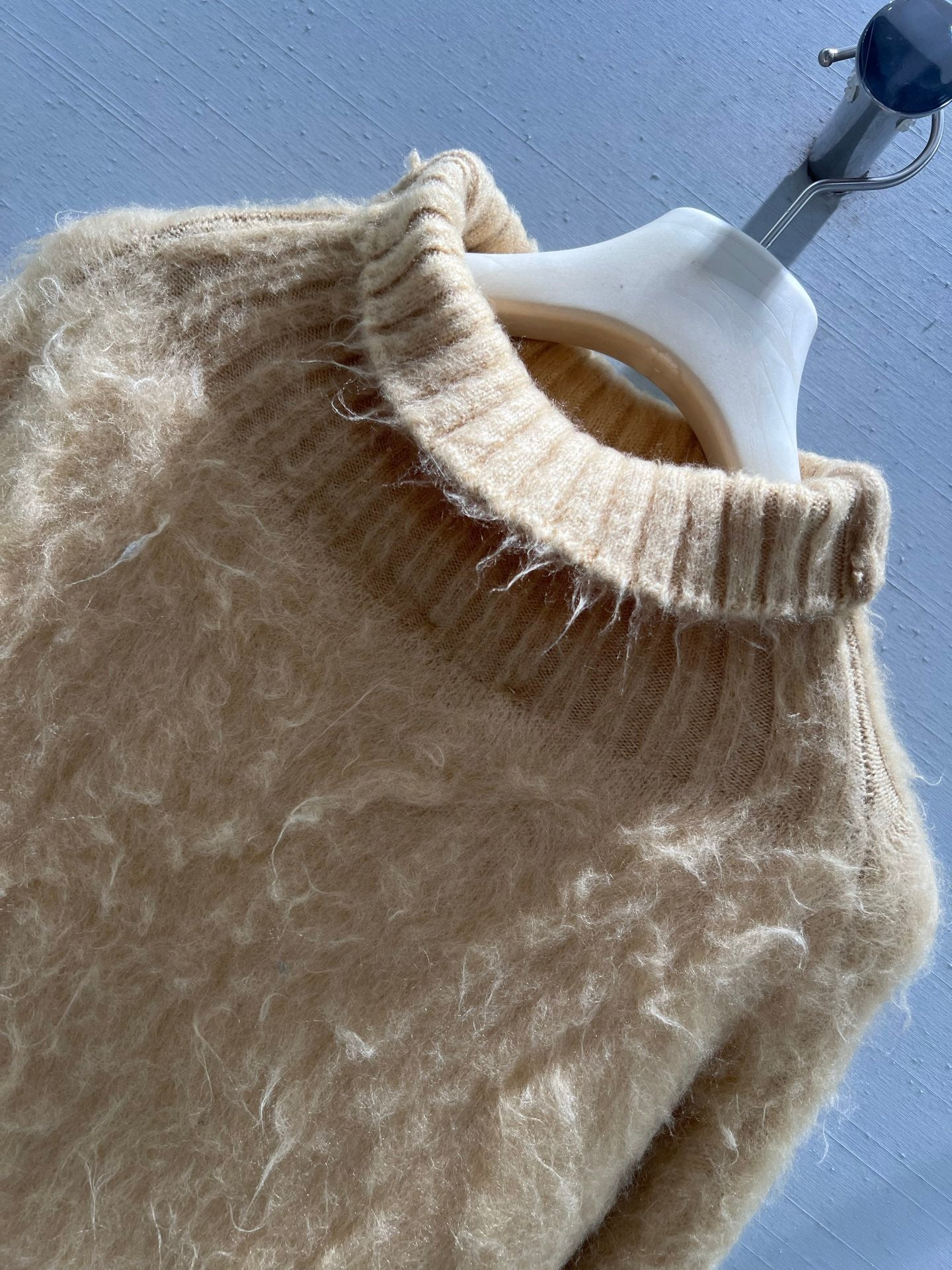 New camel-colored knitted sweater
